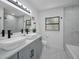 Bright bathroom with double sinks, marble countertops, and modern fixtures at 112 Peterson Ln, Palm Harbor, FL 34683