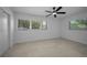 Bright bedroom with neutral walls, ceiling fan, and natural light from the large windows at 112 Peterson Ln, Palm Harbor, FL 34683