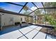 Enclosed patio with comfortable seating area and views of lush landscaping at 112 Peterson Ln, Palm Harbor, FL 34683