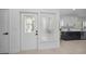 Home entryway with decorative glass door and view of modern kitchen at 112 Peterson Ln, Palm Harbor, FL 34683