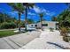 Attractive home featuring tropical landscaping and a curving concrete driveway at 112 Peterson Ln, Palm Harbor, FL 34683