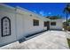 View of the side of a house with a decorative wall hanging and driveway at 112 Peterson Ln, Palm Harbor, FL 34683