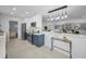 Open-concept kitchen with pendant lighting, two-tone cabinets, and seamless flow to the living area at 112 Peterson Ln, Palm Harbor, FL 34683