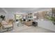 Bright living room with large windows, neutral furniture, and stylish decor at 112 Peterson Ln, Palm Harbor, FL 34683