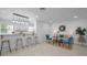Open concept living room with modern furnishings, tile floors, and ample natural light at 112 Peterson Ln, Palm Harbor, FL 34683