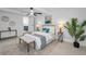 A bedroom with neutral decor, ceiling fan, and an ensuite bath, creating a peaceful retreat at 112 Peterson Ln, Palm Harbor, FL 34683