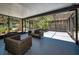 A screened-in patio with ample seating, a ceiling, and natural lighting, creating a cozy area at 112 Peterson Ln, Palm Harbor, FL 34683