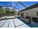 Spacious screened patio features comfortable seating and an airy atmosphere, perfect for relaxation at 112 Peterson Ln, Palm Harbor, FL 34683