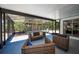 Enclosed porch with wicker couches and views of the backyard at 112 Peterson Ln, Palm Harbor, FL 34683