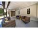Enclosed porch featuring three wicker couches with neutral walls and floor at 112 Peterson Ln, Palm Harbor, FL 34683