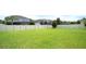Expansive green backyard featuring a sturdy white fence for privacy and security, lush lawn, and shade trees at 11408 Scribner Station Ln, Lithia, FL 33547