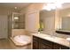 Bathroom features large soaking tub, shower and granite countertops on the vanity at 11408 Scribner Station Ln, Lithia, FL 33547