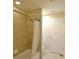 Cozy bathroom features a tiled shower and tub combination and a neutral color palette at 11408 Scribner Station Ln, Lithia, FL 33547