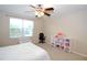 Bedroom with a window, ceiling fan, and ample closet space at 11408 Scribner Station Ln, Lithia, FL 33547