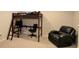 Bedroom with a bunk bed that has an attached desk, and a comfortable black chair for work or study at 11408 Scribner Station Ln, Lithia, FL 33547