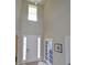 Bright foyer with soaring ceilings, a tiled floor, and a white front door with sidelights at 11408 Scribner Station Ln, Lithia, FL 33547
