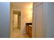 Hallway leading to the bathroom featuring tile floors and fresh paint at 11408 Scribner Station Ln, Lithia, FL 33547