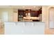 Kitchen with dark cabinets, granite countertops, and stainless steel appliances at 11408 Scribner Station Ln, Lithia, FL 33547