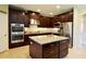 Spacious kitchen with a large island, stainless steel appliances, and rich, dark cabinetry at 11408 Scribner Station Ln, Lithia, FL 33547