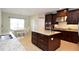 Kitchen featuring dark cabinets, granite countertops, and stainless steel appliances at 11408 Scribner Station Ln, Lithia, FL 33547