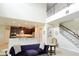 Living room featuring a staircase, an open floor plan, and a modern kitchen at 11408 Scribner Station Ln, Lithia, FL 33547