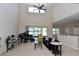 Living room with grand piano, high ceilings, an open floor plan, and sliding glass doors at 11408 Scribner Station Ln, Lithia, FL 33547