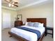 Primary bedroom with tray ceilings, a ceiling fan, and neutral colors at 11408 Scribner Station Ln, Lithia, FL 33547