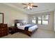 Bright Primary bedroom with ceiling fan, large bed and neutral colors at 11408 Scribner Station Ln, Lithia, FL 33547