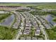 A captivating aerial view showcases a residential area nestled between serene lakes and flourishing green spaces at 11881 Ranchers Gap Dr, Odessa, FL 33556