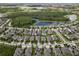Beautiful aerial view of a neighborhood with water features and lush green landscaping and neatly lined houses at 11881 Ranchers Gap Dr, Odessa, FL 33556