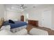 Bedroom featuring a queen bed, accent chair, and wooden floors at 11881 Ranchers Gap Dr, Odessa, FL 33556