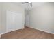 Bedroom featuring wood-look floors, a ceiling fan, and a double closet at 11881 Ranchers Gap Dr, Odessa, FL 33556