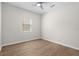 Empty bedroom featuring wood-look floors, and a ceiling fan at 11881 Ranchers Gap Dr, Odessa, FL 33556