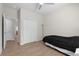 This bedroom includes wood-look floors, a ceiling fan, and a double closet at 11881 Ranchers Gap Dr, Odessa, FL 33556