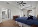 Bedroom with bathroom access, a king bed, wood floors, and recessed lighting at 11881 Ranchers Gap Dr, Odessa, FL 33556