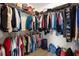 Walk-in closet with metal shelving filled with an array of clothing and personal items at 11881 Ranchers Gap Dr, Odessa, FL 33556
