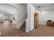 A home's foyer showcases an open floor plan with wood floors, arched doorway, and neutral colors at 11881 Ranchers Gap Dr, Odessa, FL 33556