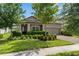 Charming one-story home with lush landscaping, including manicured shrubs and a well-maintained lawn at 11881 Ranchers Gap Dr, Odessa, FL 33556