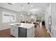 Bright kitchen with an island and stainless steel appliances. Opens to the living area at 11881 Ranchers Gap Dr, Odessa, FL 33556