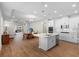 Open-concept kitchen with white cabinets, stainless steel appliances, a central island, and wood floors at 11881 Ranchers Gap Dr, Odessa, FL 33556
