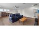 Spacious living room with wood-look floors, a ceiling fan, and comfortable seating at 11881 Ranchers Gap Dr, Odessa, FL 33556