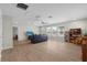 Spacious living room with wood-look floors, ceiling fan, and ample natural light at 11881 Ranchers Gap Dr, Odessa, FL 33556