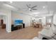 Open-concept living area with kitchen, dining, and living spaces, featuring wood flooring at 11881 Ranchers Gap Dr, Odessa, FL 33556