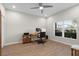 Bright, well-lit office with a ceiling fan, wood floors, large window, and simple furnishings at 11881 Ranchers Gap Dr, Odessa, FL 33556
