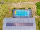 Birds-eye view showcases solar panels, screened-in pool, and backyard, emphasizing privacy at 12546 Brookside St, Spring Hill, FL 34609