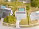 Aerial view of home showing solar panels, screened-in pool, and surrounding neighborhood at 12546 Brookside St, Spring Hill, FL 34609