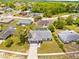Overhead view of a home with a driveway, landscaping, and surrounding neighborhood at 12546 Brookside St, Spring Hill, FL 34609