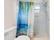 Bathroom with tiled shower stall, tropical print shower curtain, tile floor and toilet at 12546 Brookside St, Spring Hill, FL 34609