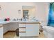Bathroom with light blue cabinets, a vanity, a mirror, linoleum flooring, and a toilet at 12546 Brookside St, Spring Hill, FL 34609