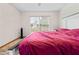 Bright bedroom featuring a large window with blinds, cozy carpet, and view of the outdoors at 12546 Brookside St, Spring Hill, FL 34609